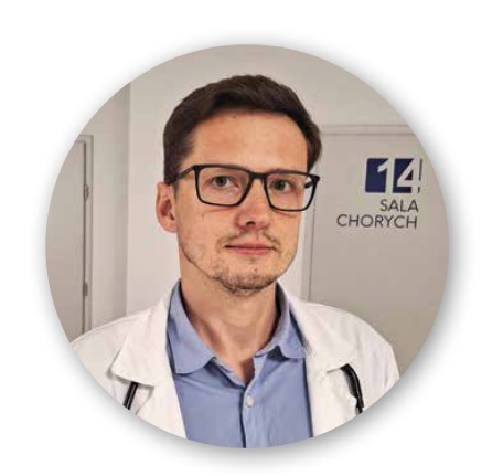 zdjęcie przedstawia lekarza pracującego w szpitalu w Wolicy w fartuchu lekarskim, w okularach ciemne włosy